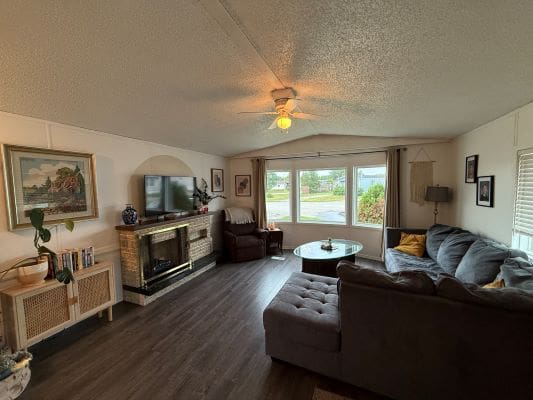 Cozy living room with large windows and sofa.