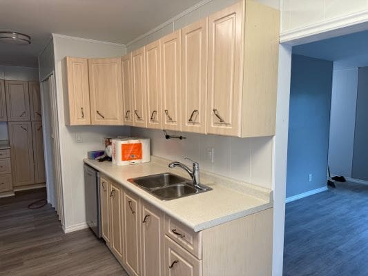 Modern kitchen with light wood cabinets.