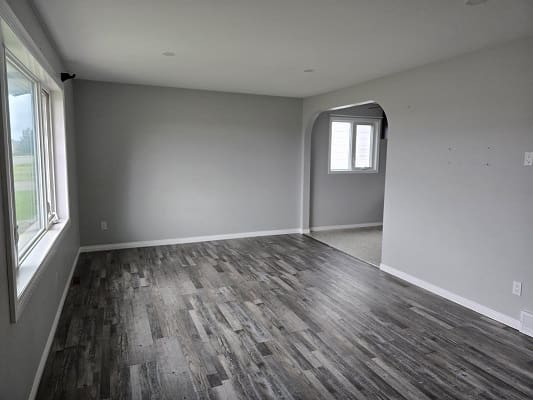Empty room with gray walls and flooring.