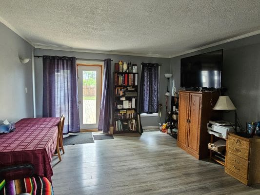 Living room with table and TV setup.