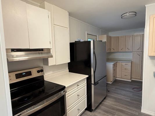 Modern kitchen with appliances and wooden cabinets.