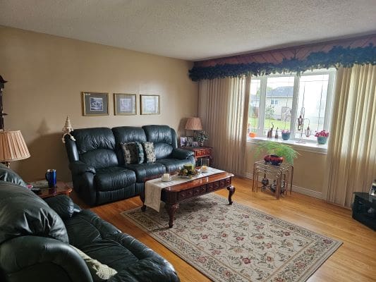 Cozy living room with green sofas.