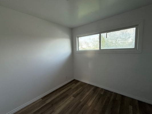 Small empty room with large window.