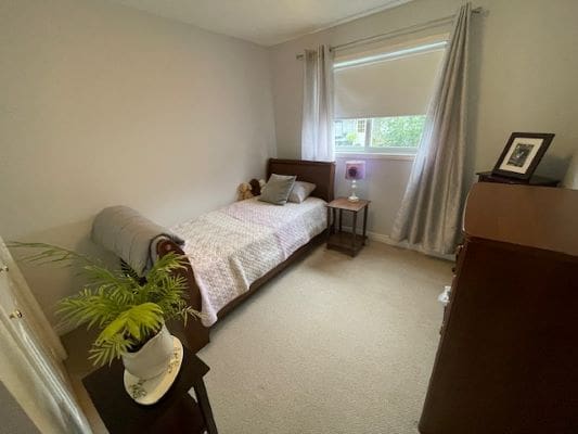 Small bedroom with single bed and window.