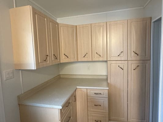 Wooden kitchen cabinets with countertop corner.