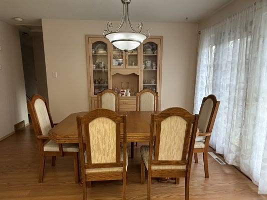 Dining room with wooden table and chairs.
