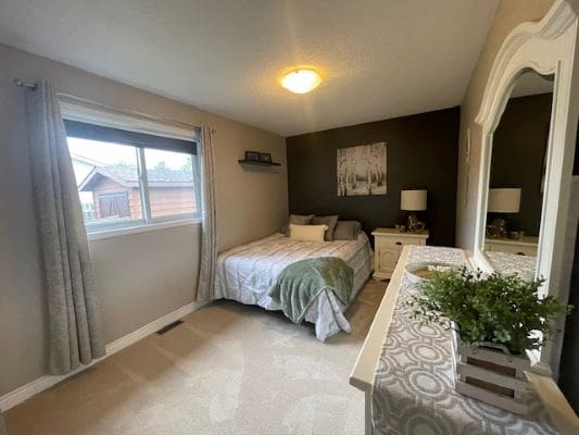 Cozy bedroom with bed and dresser.