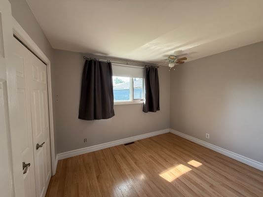 Empty room with wooden floor and window.