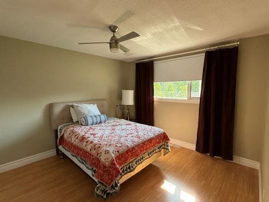Cozy bedroom with bed and window light.
