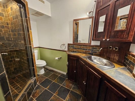 Rustic bathroom with slate tile design.