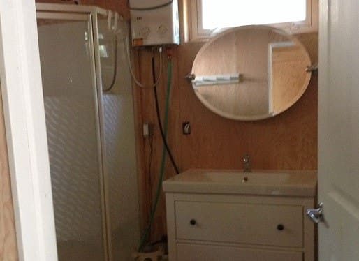 Small bathroom with shower and sink.