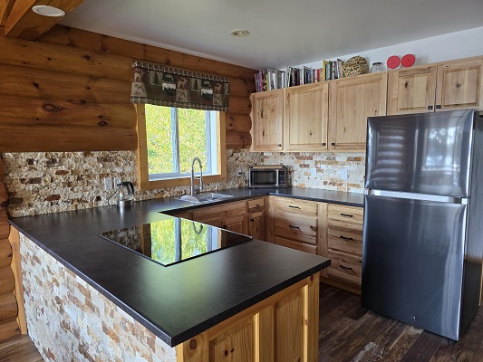 Rustic kitchen with wooden cabinets and countertops.
