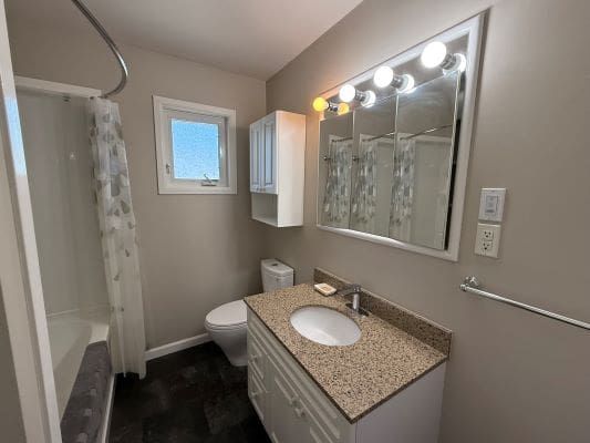 Modern bathroom with vanity and shower.