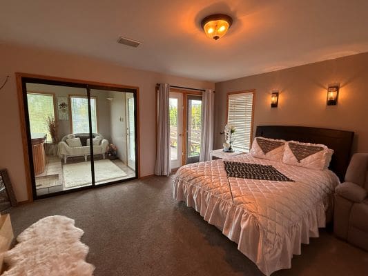 Cozy bedroom with large bed and windows.