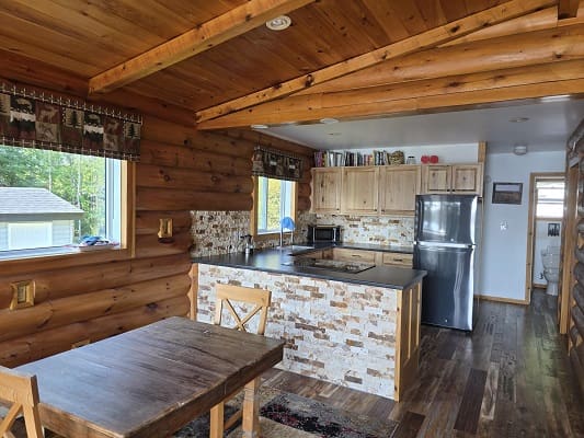 Rustic kitchen and dining area with wood decor.