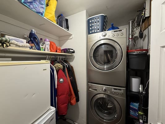 Laundry room with stacked washer and dryer.