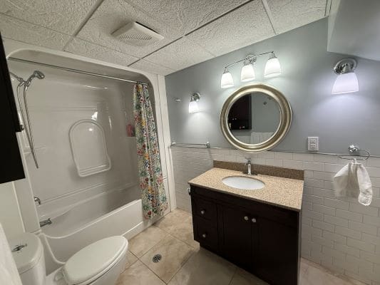 Modern bathroom with vanity and bathtub.