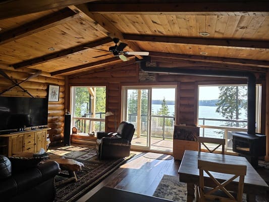 Cozy cabin interior with lake view.