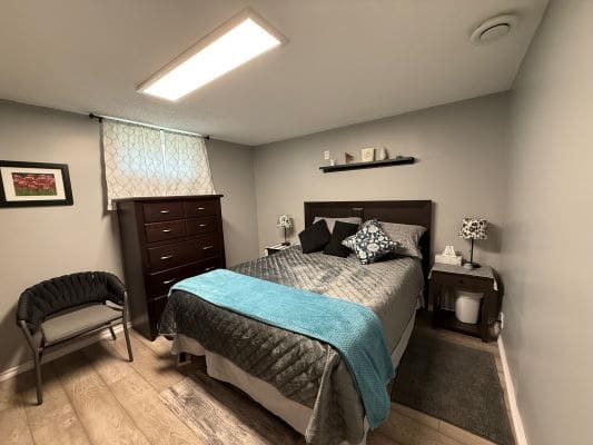 Cozy bedroom with bed and dresser.