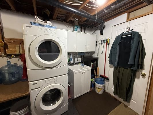 Laundry room with stacked washer and dryer.