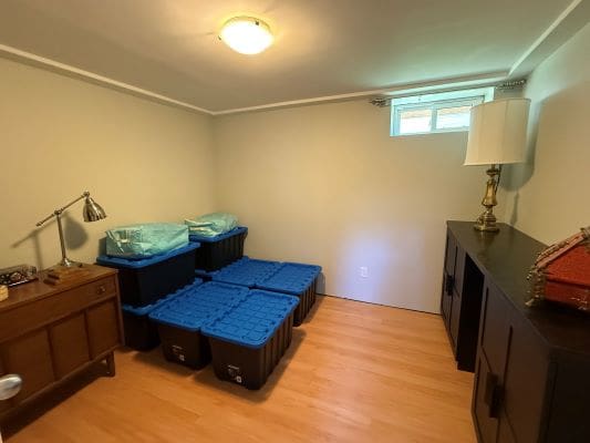 Storage room with bins and furniture.