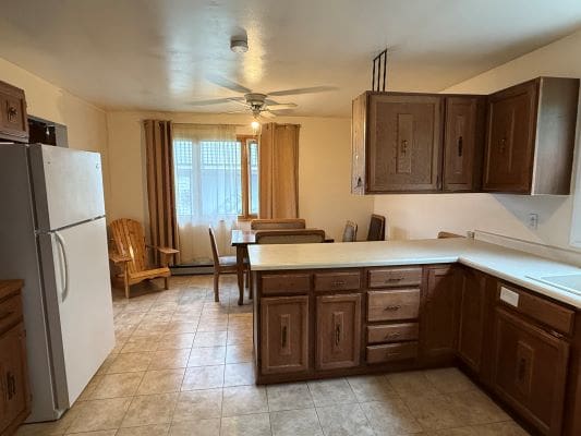 Kitchen with wooden cabinets and dining area.