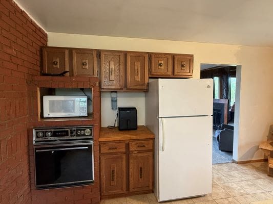 Kitchen with wooden cabinets and appliances.
