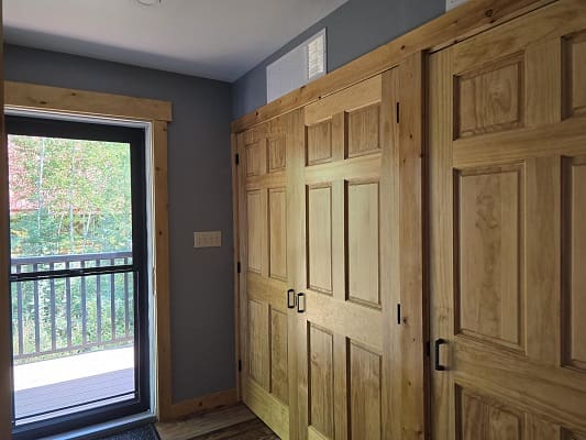 Hallway with wooden doors and glass door.