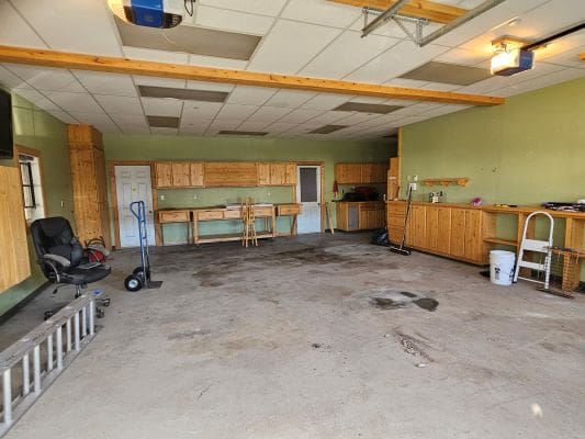 Spacious garage with workbenches and tools.