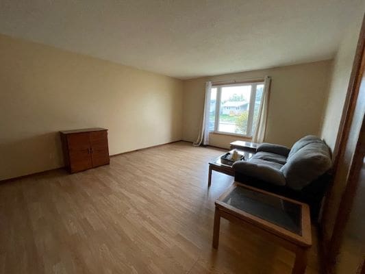 Spacious living room with minimal furniture.