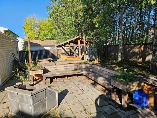 Outdoor patio with benches and fire pit.