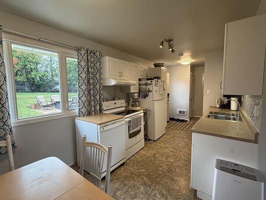 Kitchen with white cabinets and appliances.