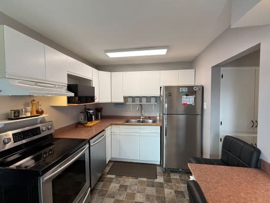 Modern kitchen with stainless steel appliances.