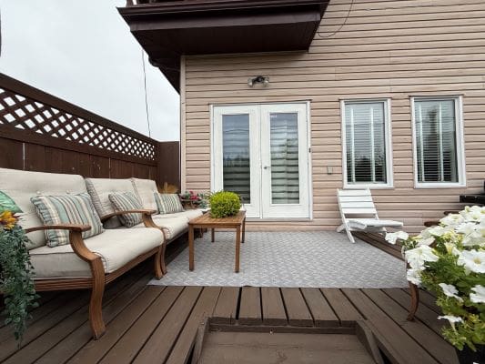 Outdoor patio with seating and flowers.