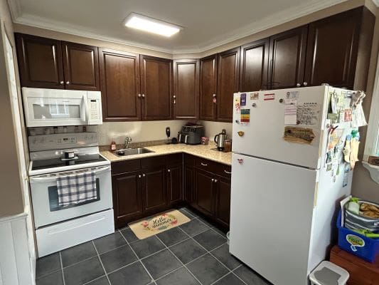 Small kitchen with dark wood cabinets.