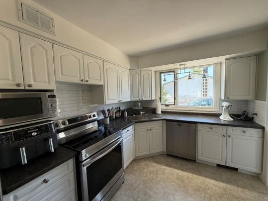 Modern kitchen with stainless steel appliances.