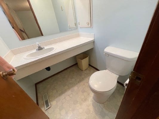 Small bathroom with sink and toilet.