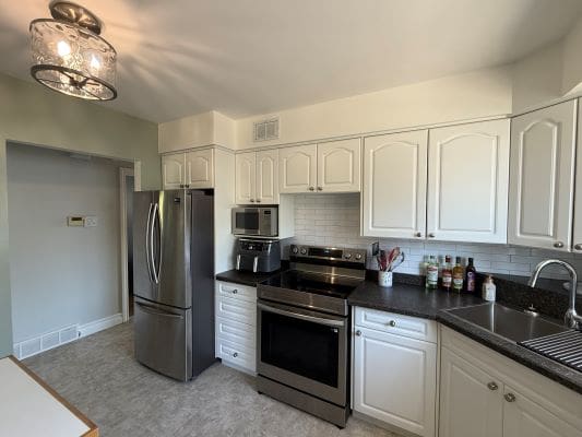 Modern kitchen with stainless steel appliances.