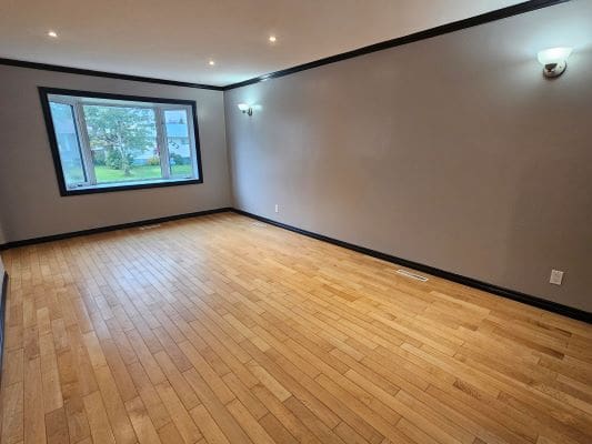 Empty room with wooden floor and window.