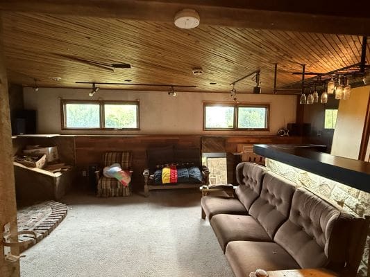 Cozy living room with wooden ceiling.