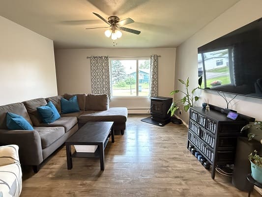 Living room with couch and television.