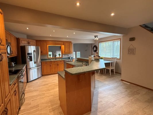 Spacious kitchen with wooden cabinets and island.