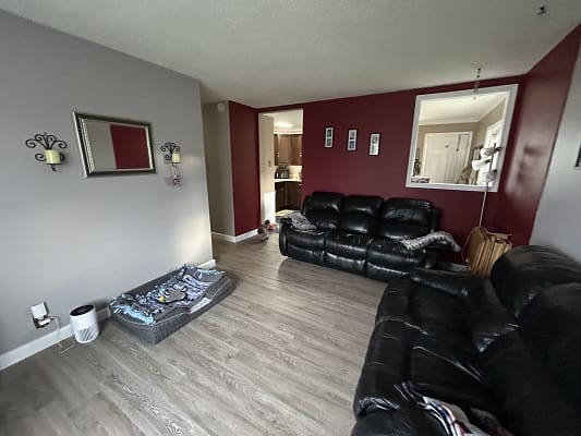 Living room with black leather couches.
