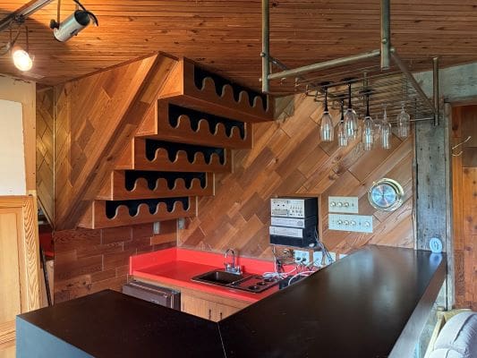 Wooden bar area with wine rack shelving.
