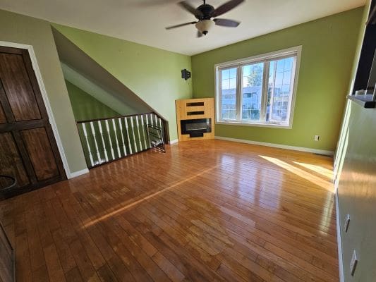 Empty room with wooden floor and window.