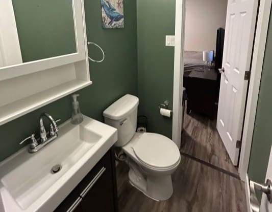 Small bathroom with green walls and sink.