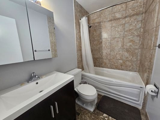 Modern bathroom with tub and vanity.