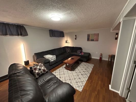 Cozy living room with black leather sofas.