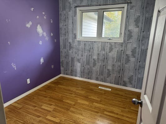 Empty room with purple and gray walls.