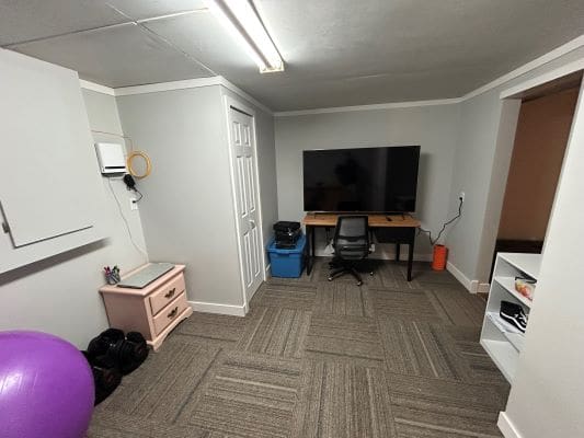 Home office with desk and large monitor.